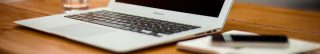 stock photo showing laptop, phone, and water glass